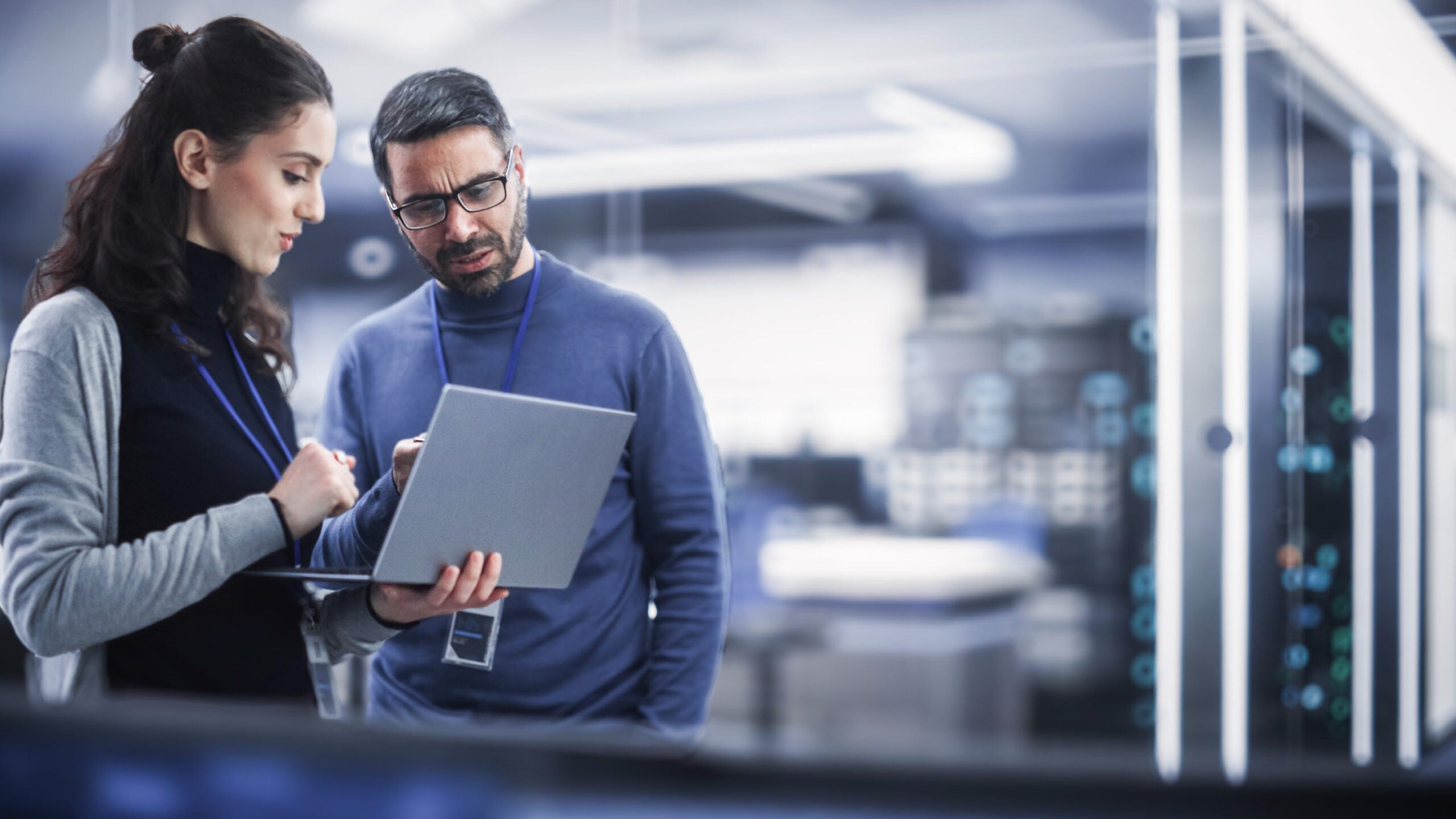 Coworkers looking at laptop