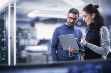 Man and woman working on laptop