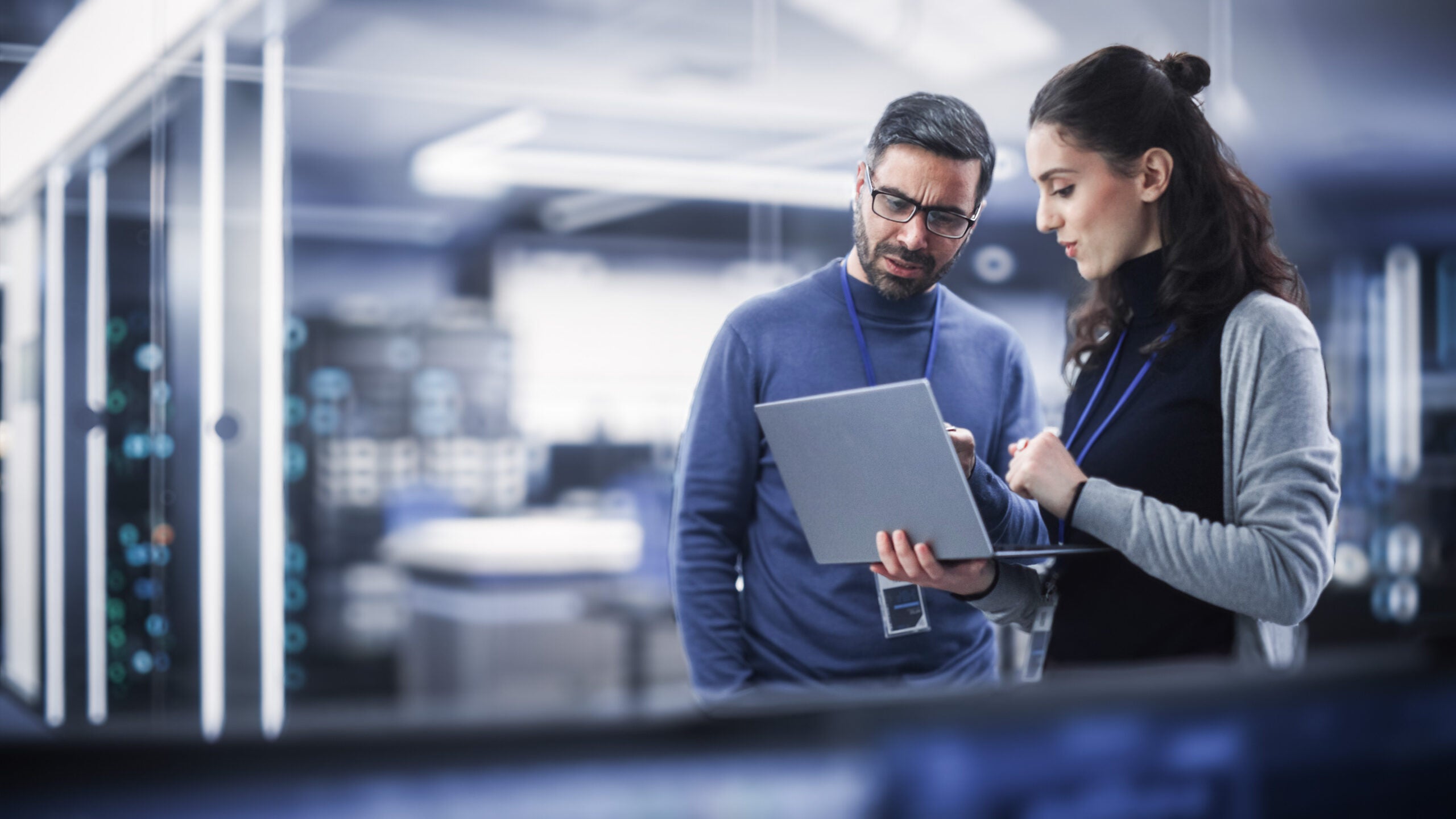 Man and woman working on laptop