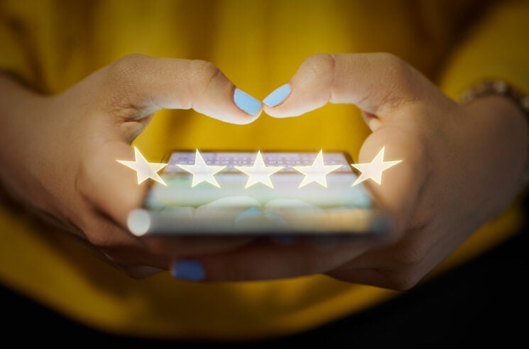 Person adding review on their phone