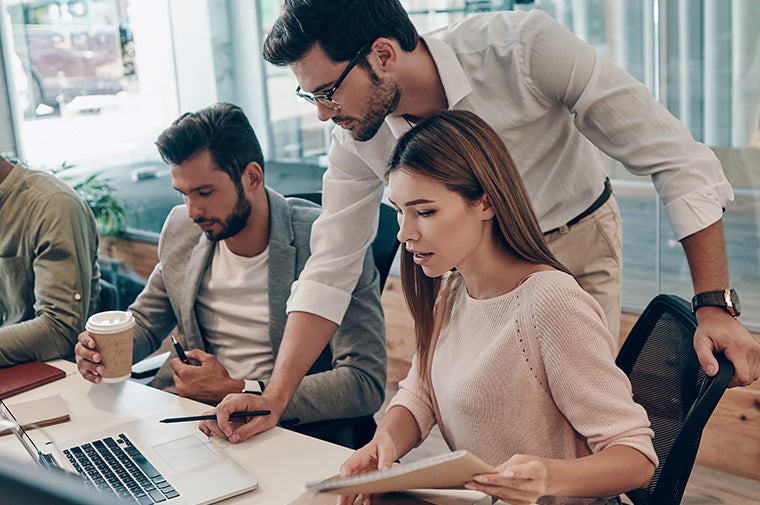 Co-workers reviewing data at a desk