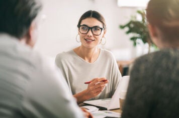 Woman interviewing couple
